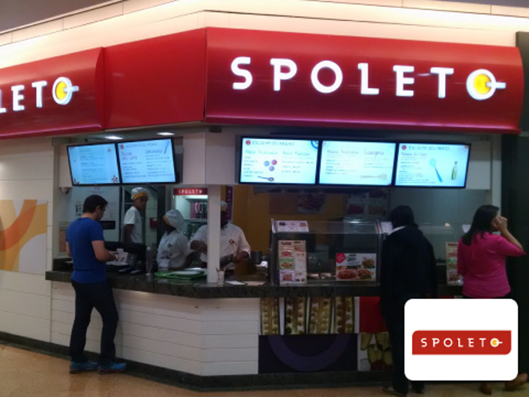 Spoleto restaurant storefront with five digital menu displays above the counter