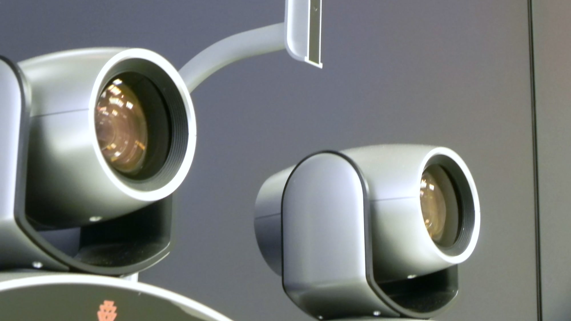 Close-up of two professional videoconferencing cameras displayed on the Yamana video wall